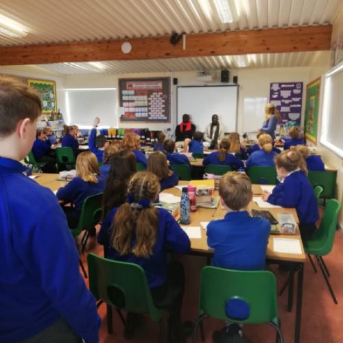 Ugandan visitors talk to Year 5